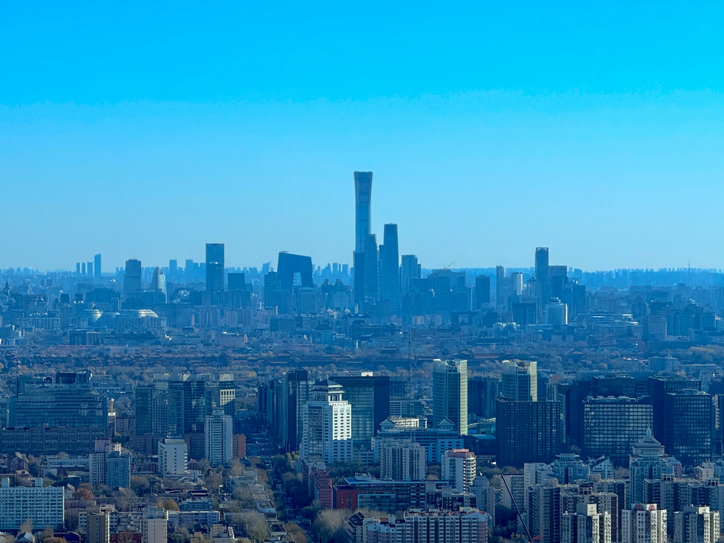 Modern skyscrapers and residential buildings fill the dense city landscape.